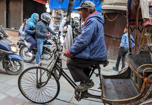 A man riding a rickshaw