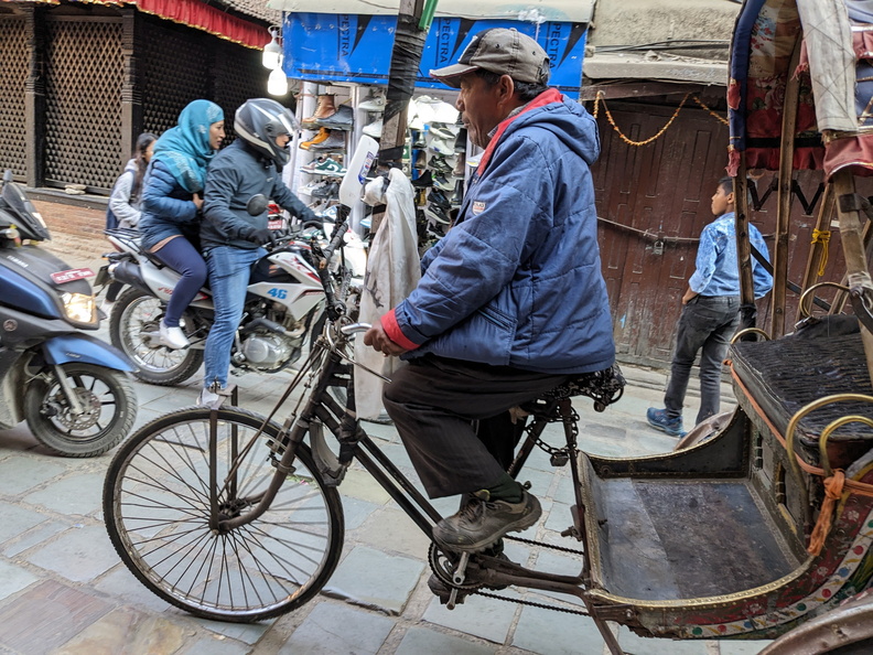 A man riding a rickshaw